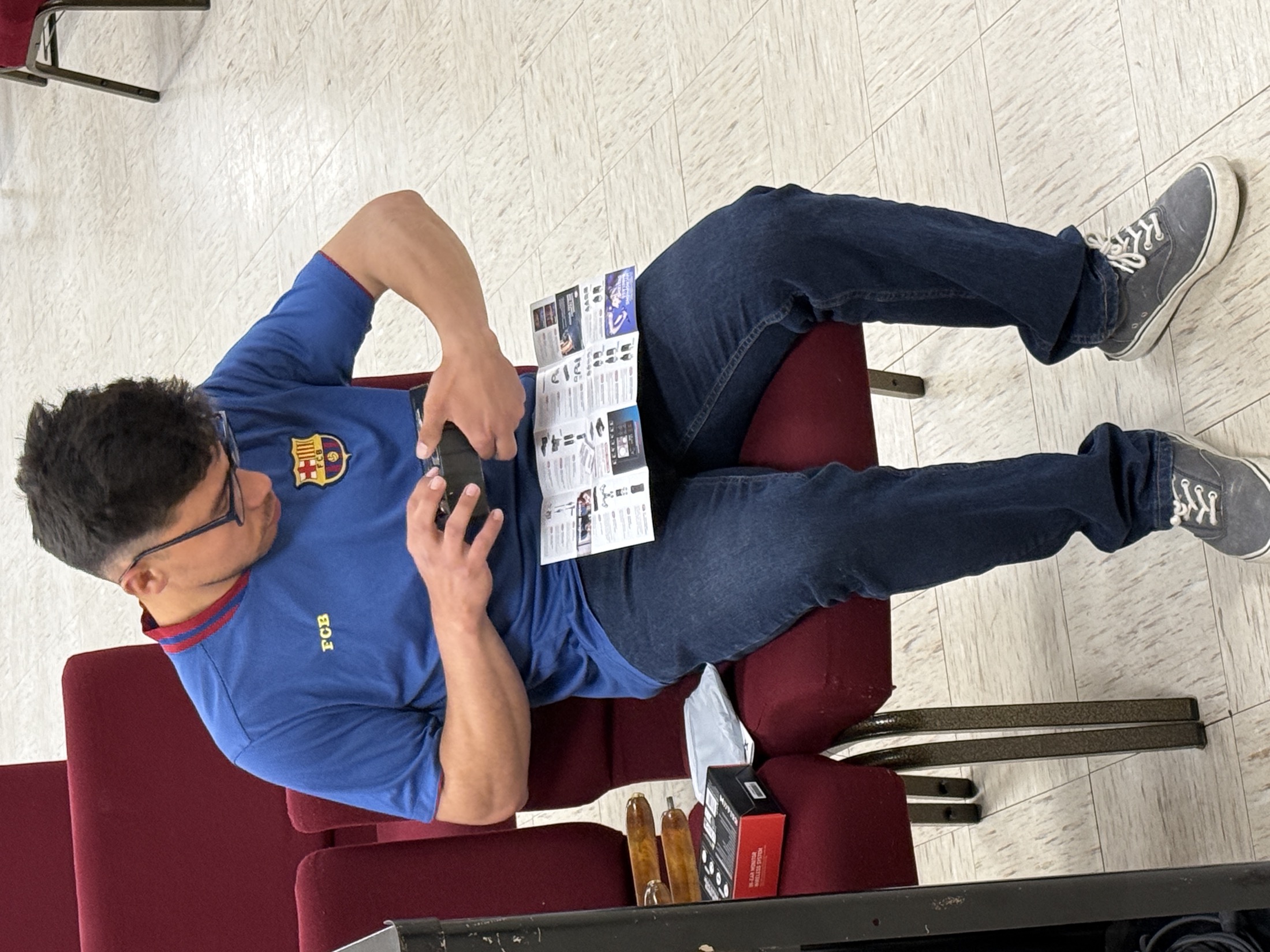 Church volunteer seated with an IEM pack and printed setup guide