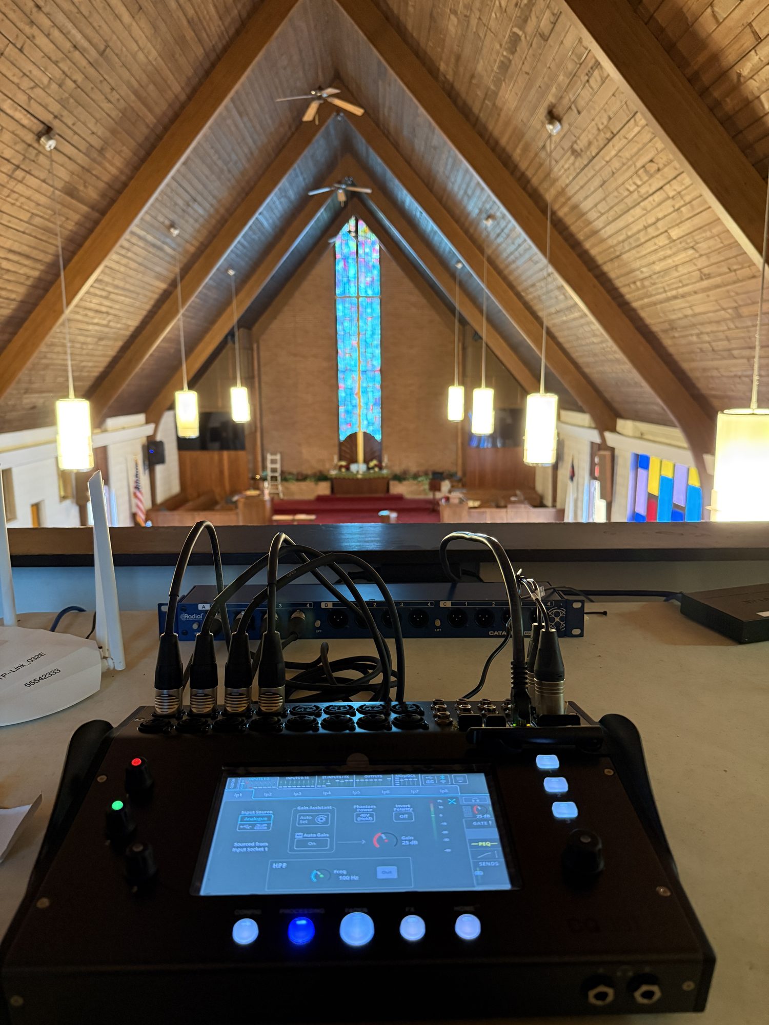 Digital audio console set up in the church sanctuary with the chancel visible in the background