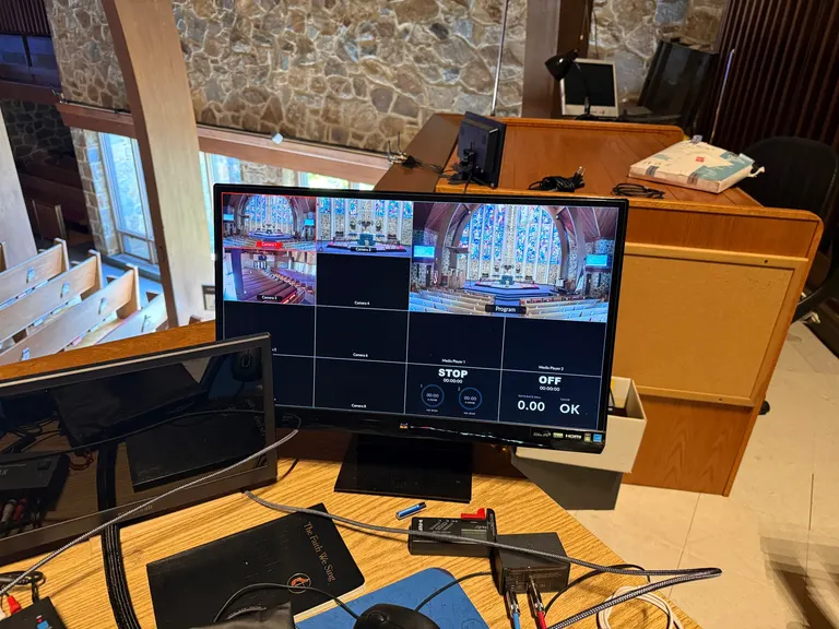 Production monitor showing three church camera feeds and a program view
