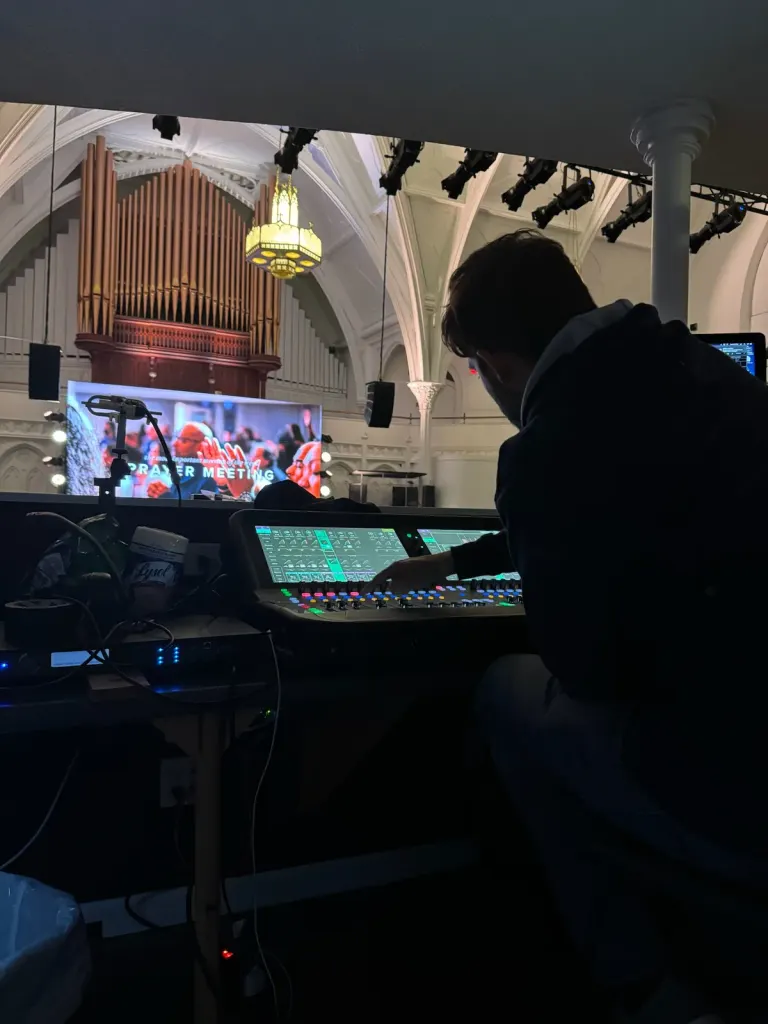Wide view of a church worship stage and seating environment during service setup