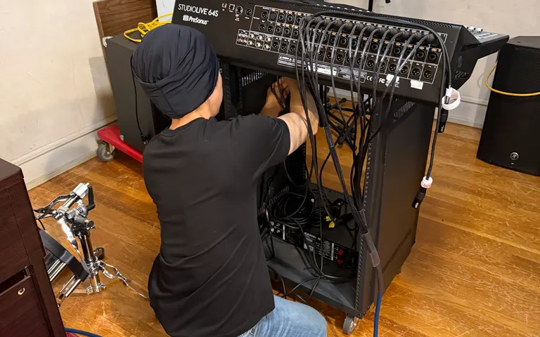 Technician wiring a PreSonus StudioLive mixer rack during a church audio upgrade