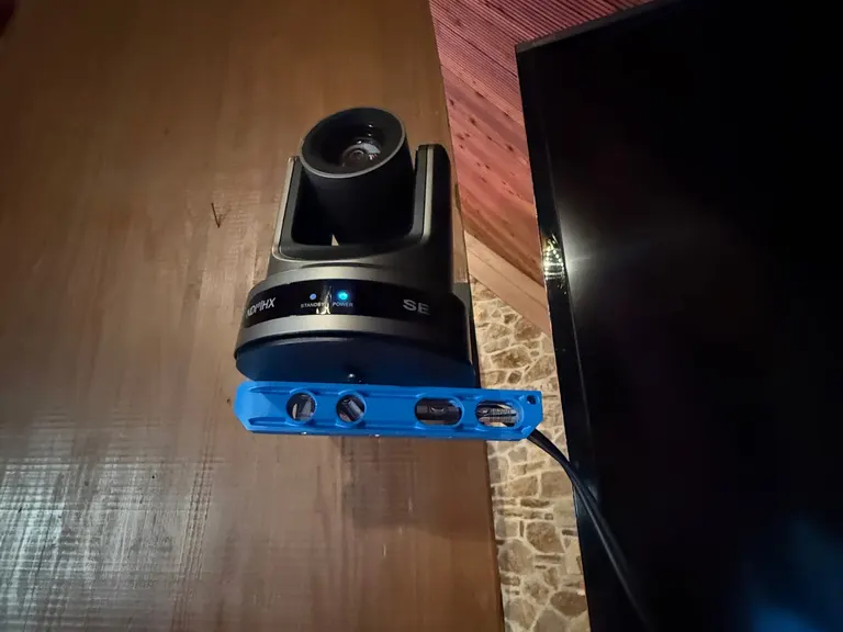 Close view of a mounted PTZ camera beside a sanctuary display
