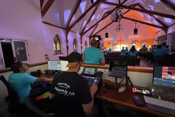 Church AV team operating mixing console during live worship service