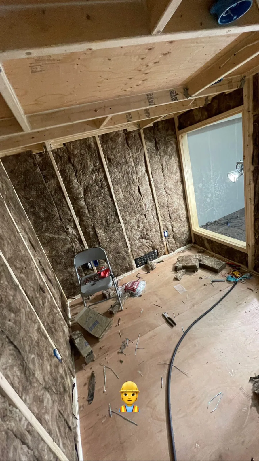 Church control room under construction with exposed wall framing and installation work in progress