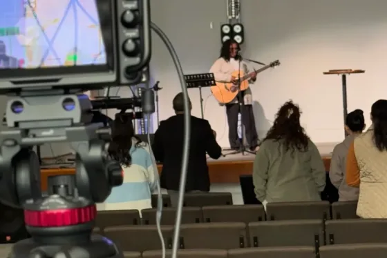 Camera operator capturing live worship service at a church